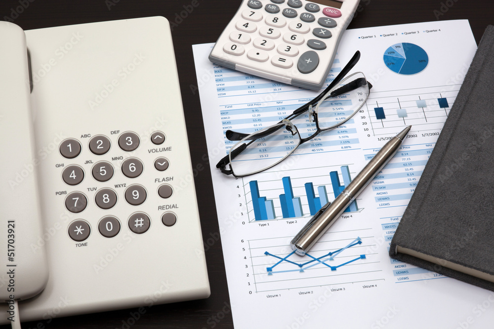 business report with telephone on a table business report with telephone on a table