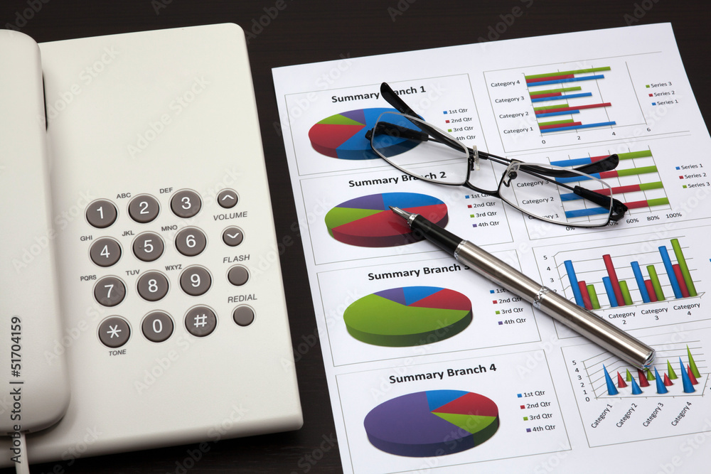 business report with telephone on a table business report with telephone on a table