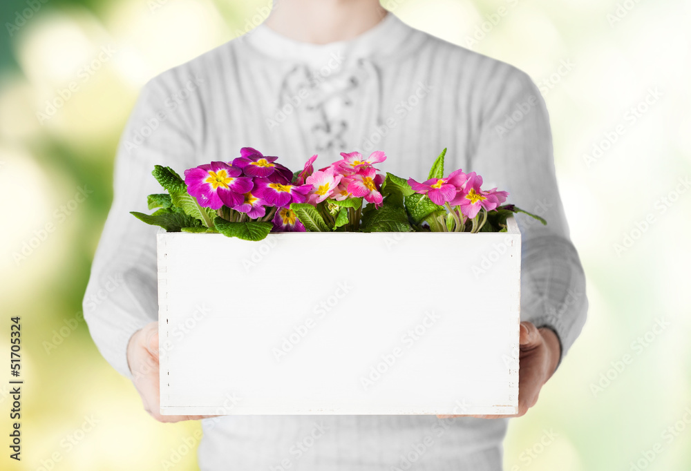 man holding big pot with flowers
