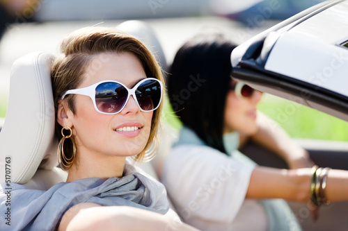 Close up of girls wearing sunglasses in the convertible car