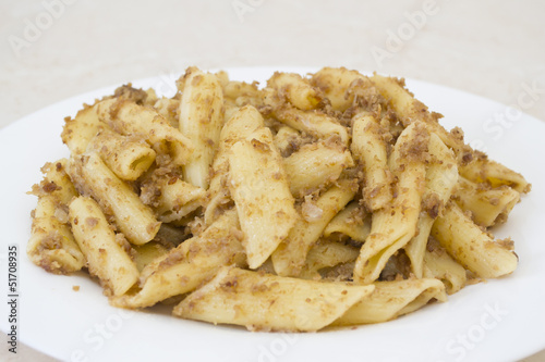 Italian penne pasta with chopped meat