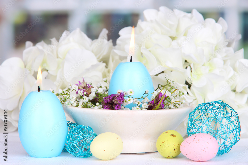 Fototapeta premium Easter candles with flowers close up