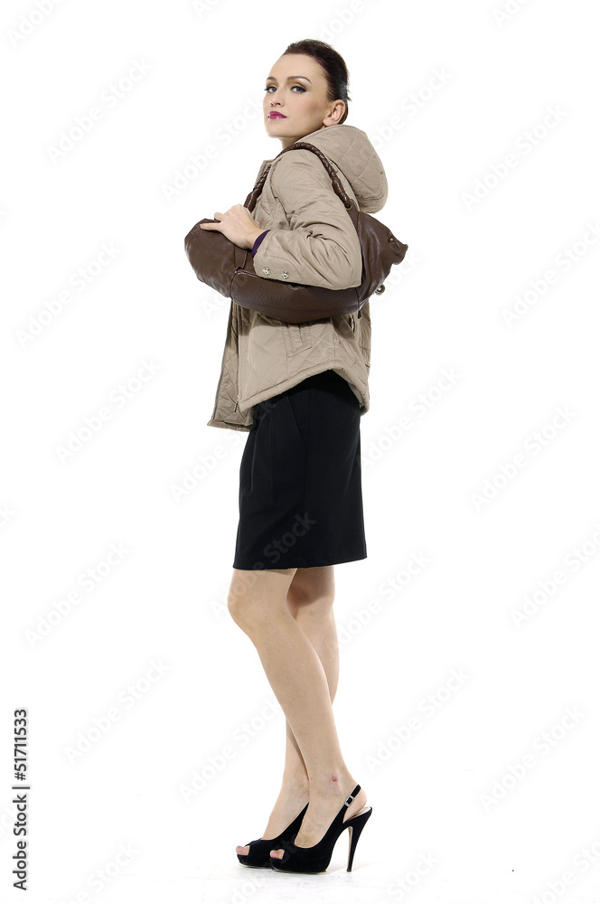 Full length of fashion girl with bag posing in the studio Full length of fashion girl with bag posing in the studio