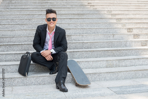 Manager with skateboard © DragonImages