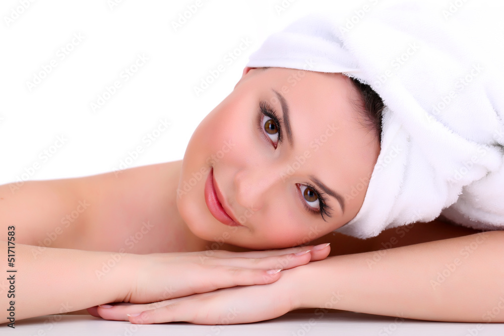 Beautiful young woman with towel on her head isolated on white
