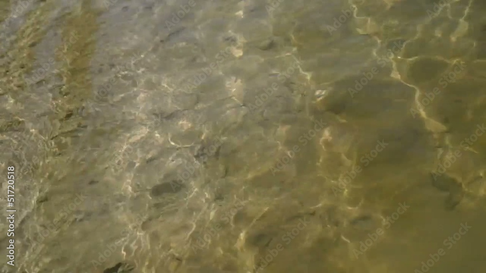transparent water in shallow with glare from sun transparent water in shallow with glare from sun