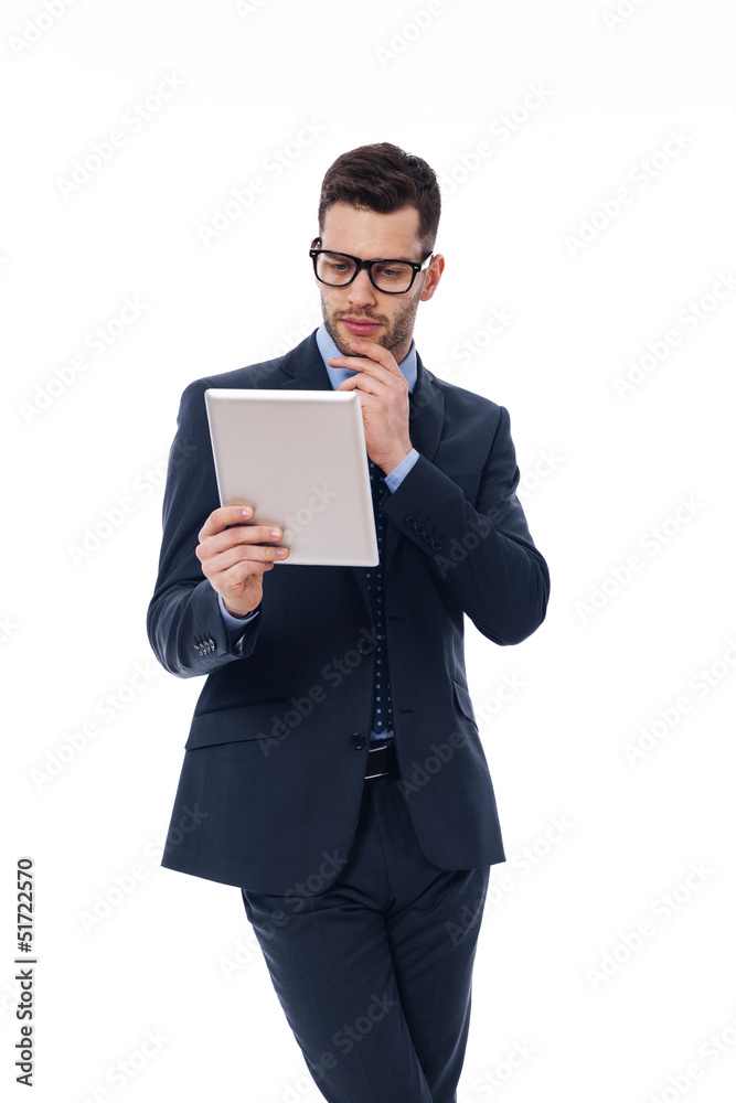 Focused man working with a digital tablet Focused man working with a digital tablet