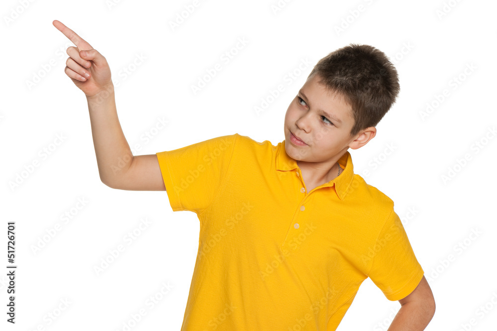 Boy in yellow shirt shows her finger to the side Boy in yellow shirt shows her finger to the side