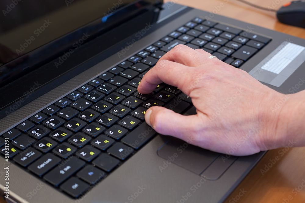 man's hand on a computer keyboard