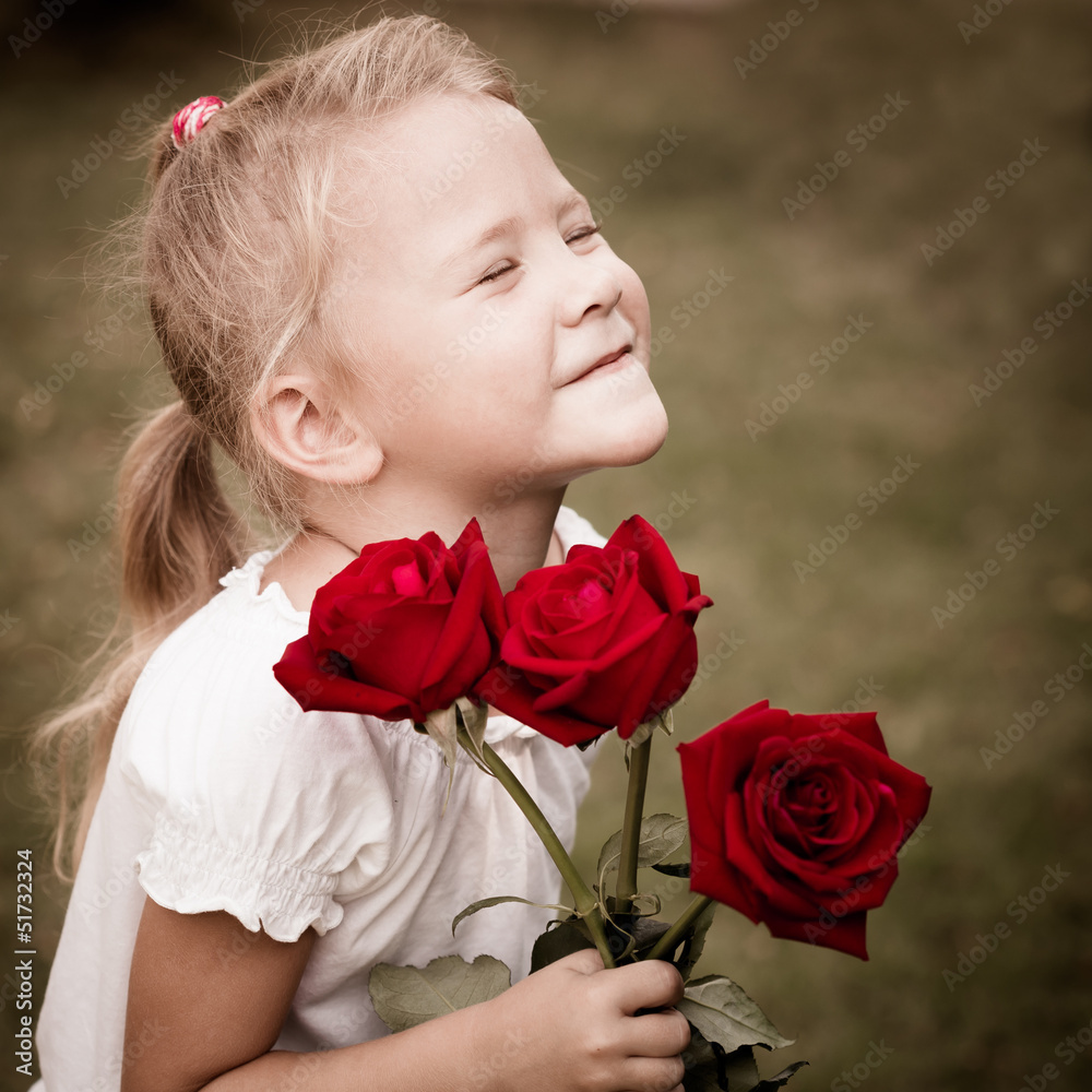 happy child with a bouquet of red roses