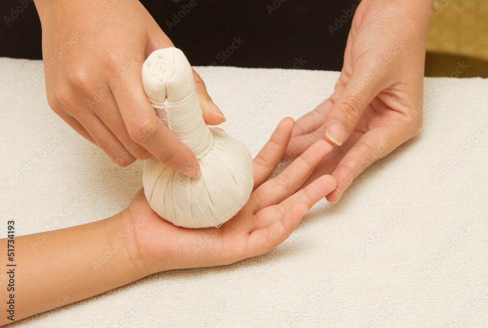 Children massage hand with herbal compress balls Children massage hand with herbal compress balls