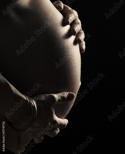 Close up on expectant mother belly