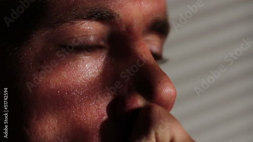 Close up of a nervous, agitated man sweating