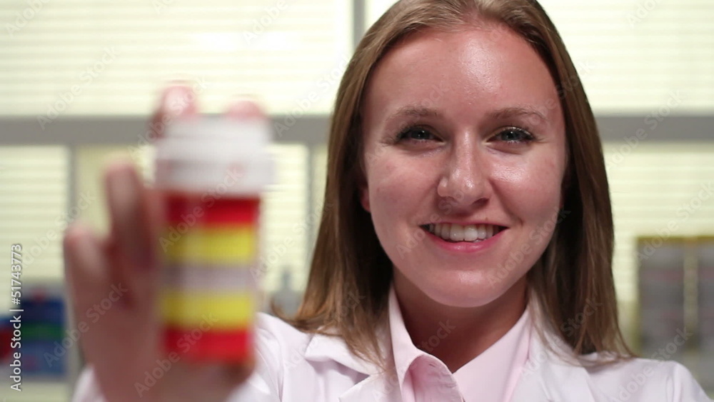Pharmacist holding prescription pill, shift focus Pharmacist holding prescription pill, shift focus