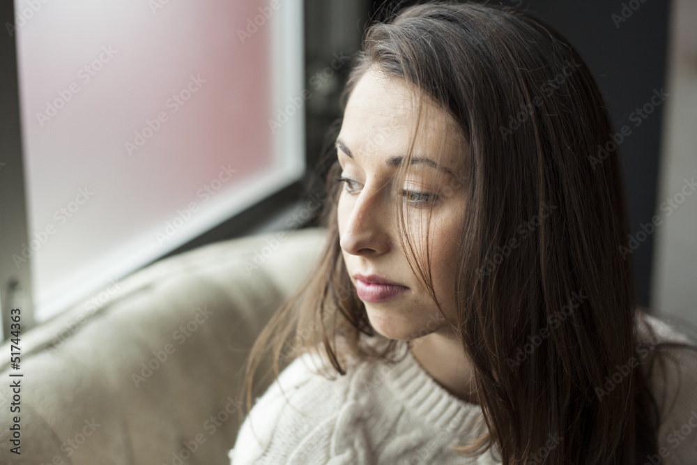 Beautiful Young Woman with Brown Hair and Eyes Thinking