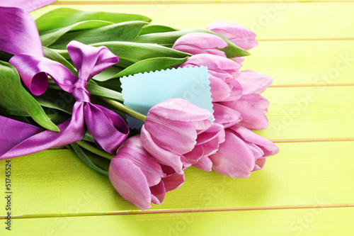 Fototapeta Naklejka Na Ścianę i Meble -  Beautiful bouquet of purple tulips on green wooden background