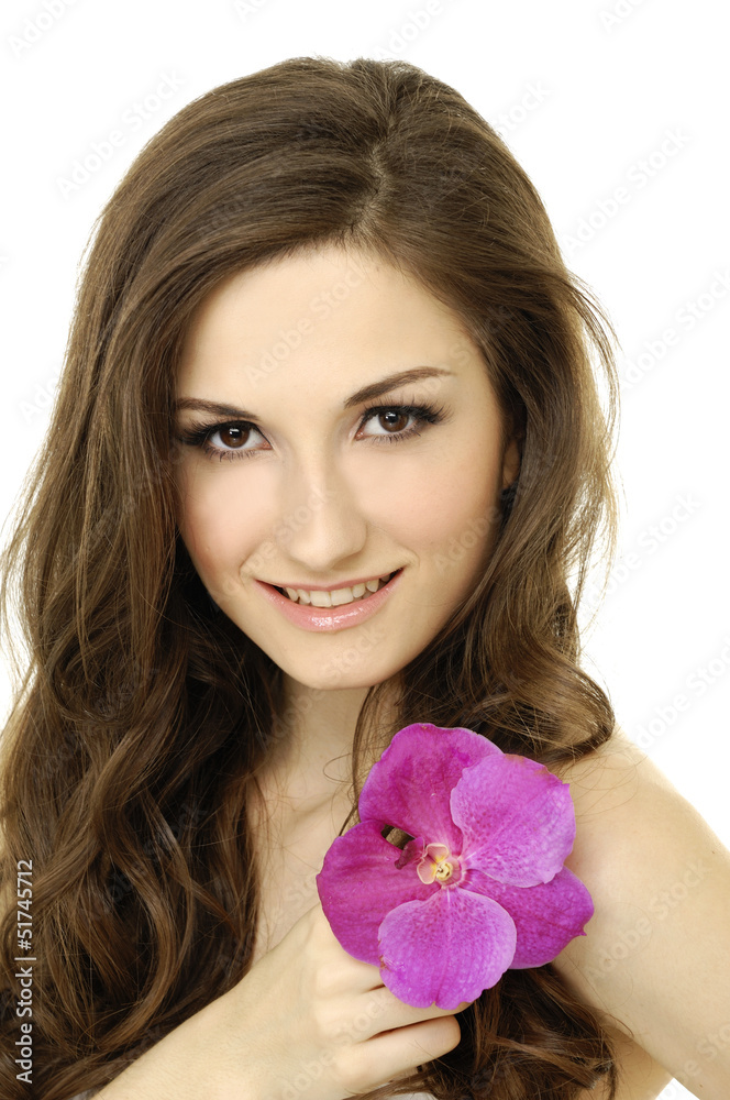 Beautiful girl holding orchid flower in her hands Beautiful girl holding orchid flower in her hands