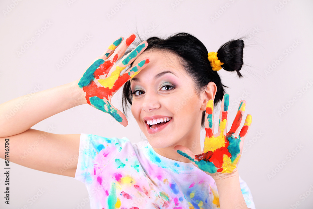 Young pretty painter with hands in paint, on gray background Young pretty painter with hands in paint, on gray background