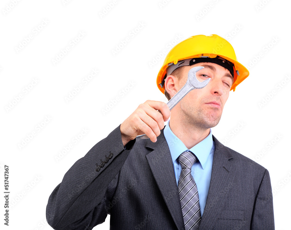 Young businessman in helmet with wrench isolated on white. Young businessman in helmet with wrench isolated on white.