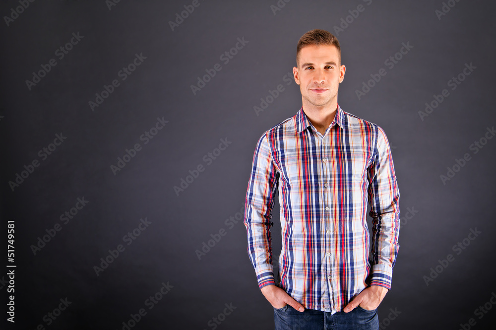 Man overdark background in squared shirt