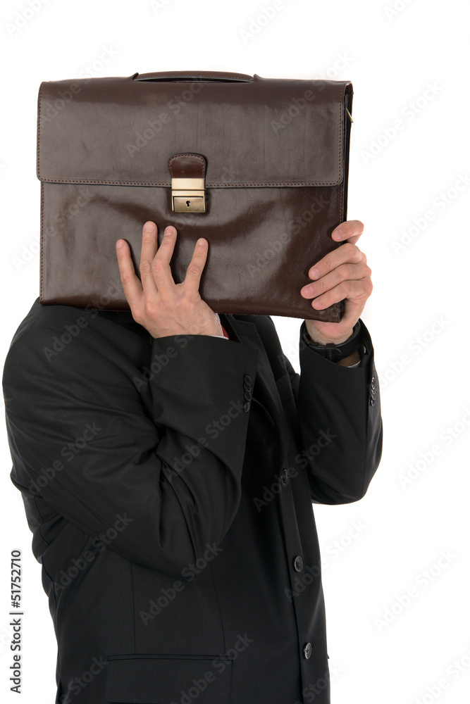 Businessman hiding behind a briefcase isolated on white backgrou Businessman hiding behind a briefcase isolated on white backgrou