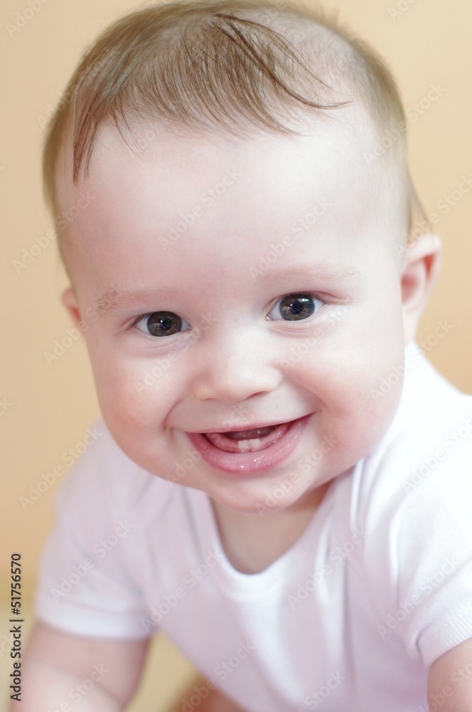 portrait of the happy laughing baby age of 7 months