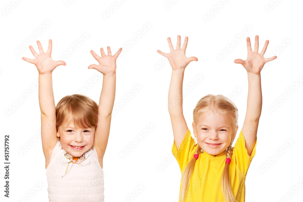 Two little girls raising their hands up. Young students Two little girls raising their hands up. Young students