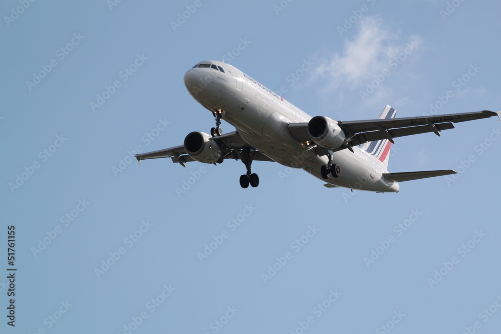 Large passenger airplane flying in the blue sky