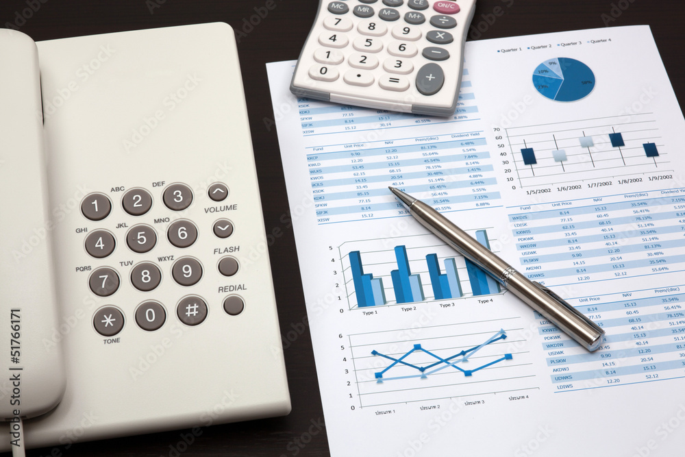 business report with telephone on a table business report with telephone on a table