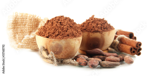 Cocoa powder in wooden bowls and spices, isolated on white