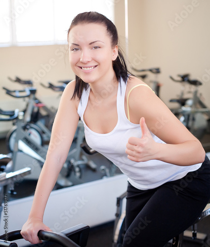 beautiful woman on an exercise bike at the gym 