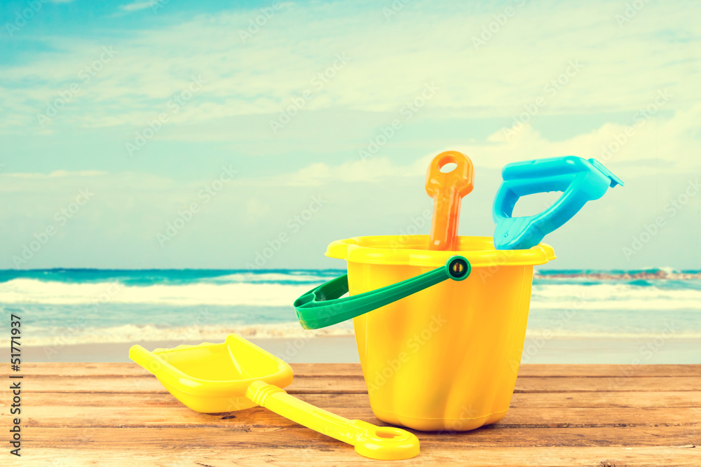 Beach items on wooden deck over sea background Beach items on wooden deck over sea background