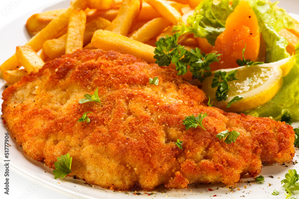 Fototapeta premium Pork chop, French fries and vegetables