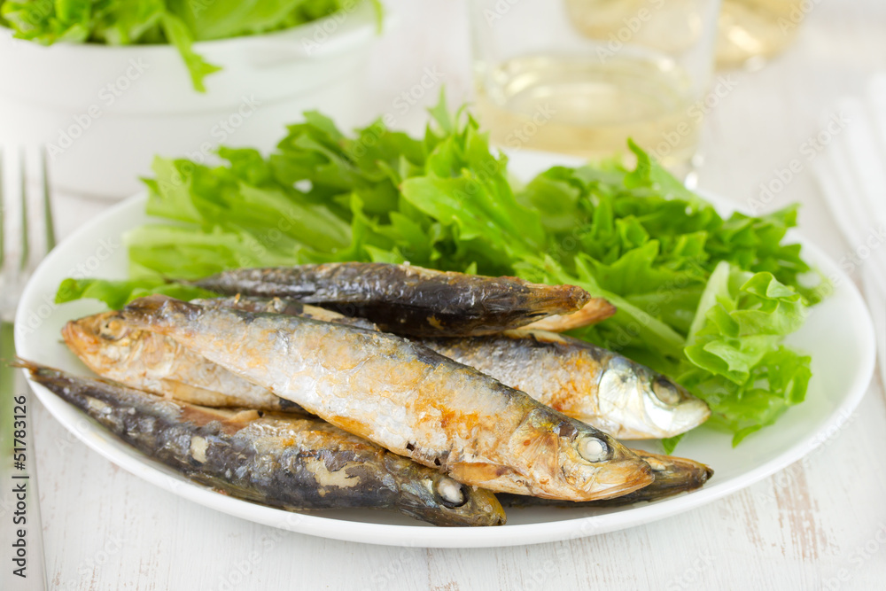 sardine with salad on white plate sardine with salad on white plate