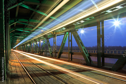 Tram in traffic on the bridge at night