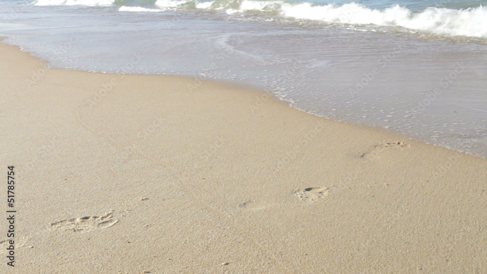 Close Up Of Man Walking Along Beach And Into Sea Close Up Of Man Walking Along Beach And Into Sea