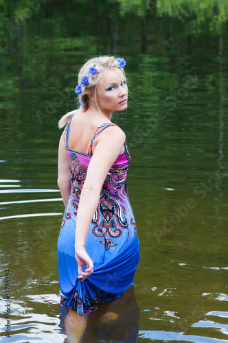 Fototapeta Naklejka Na Ścianę i Meble -  Shot of beautiful woman goes across the pond