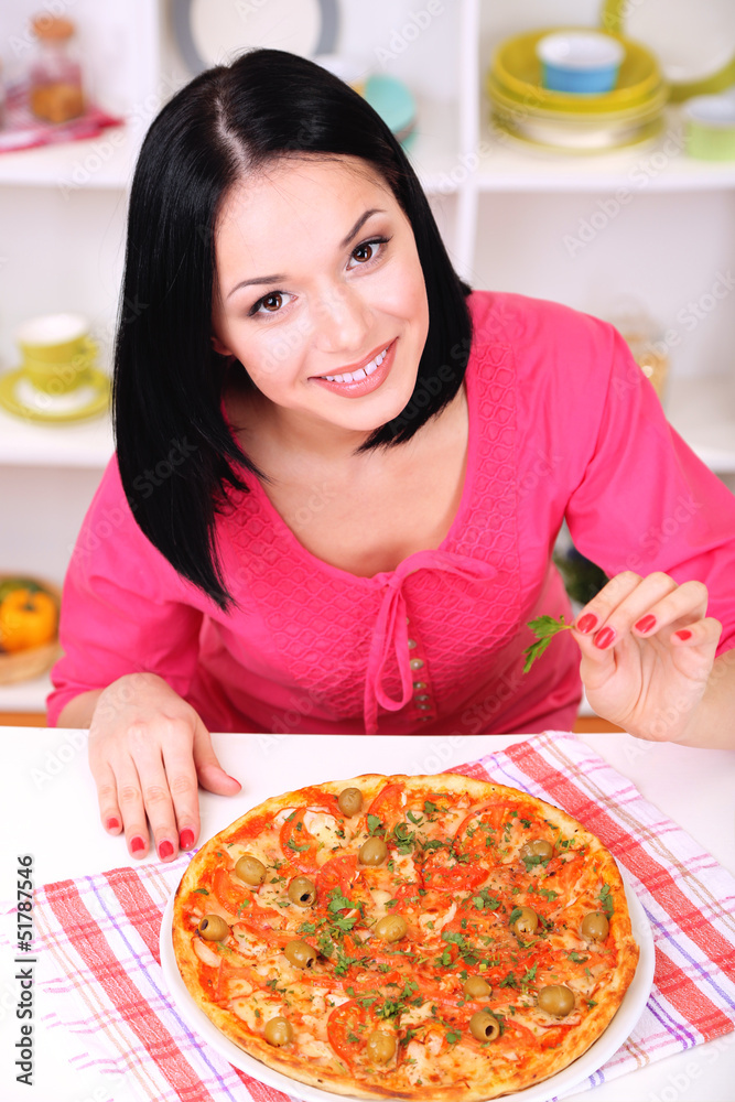Beautiful girl with delicious pizza on kitchen background Beautiful girl with delicious pizza on kitchen background