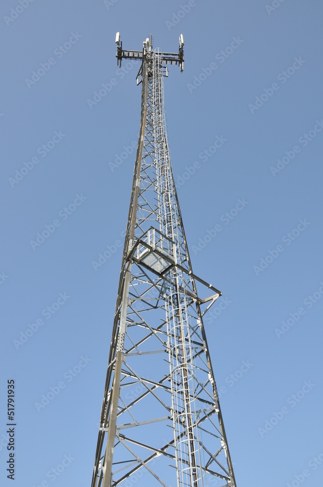 Telecommunication cell phone tower against blue sky Telecommunication cell phone tower against blue sky