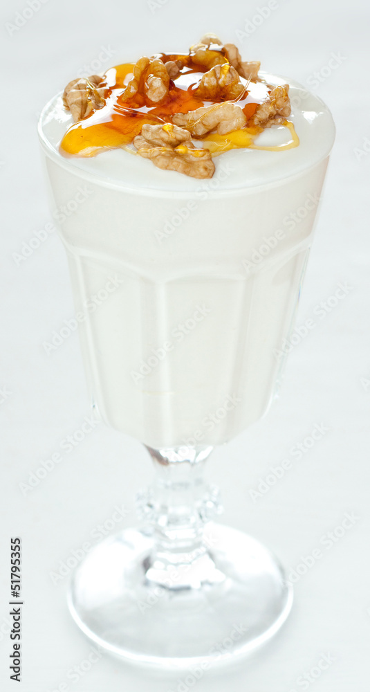 Yogurt with walnuts and gold honey - traditional greek dessert Yogurt with walnuts and gold honey - traditional greek dessert
