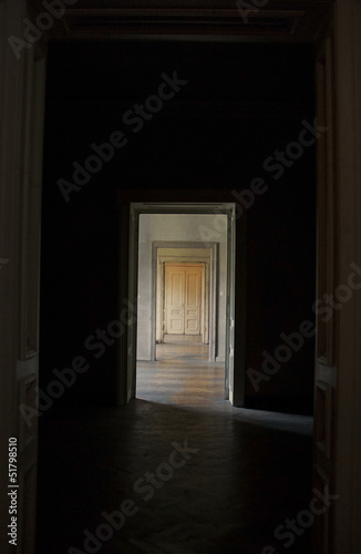 Closed door at the end of the hallway, rite of passage concept. © lava4images