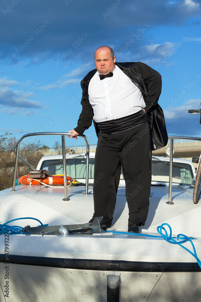 Fat man in tuxedo on deck boat Stock Photo | Adobe Stock
