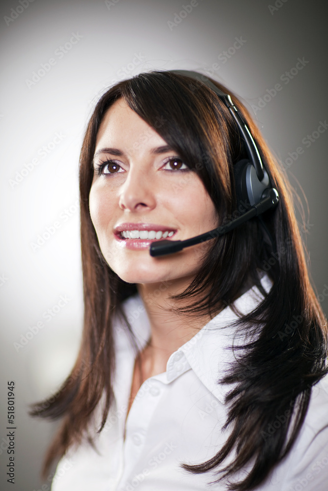 Beautiful call centre operator taking a call Beautiful call centre operator taking a call