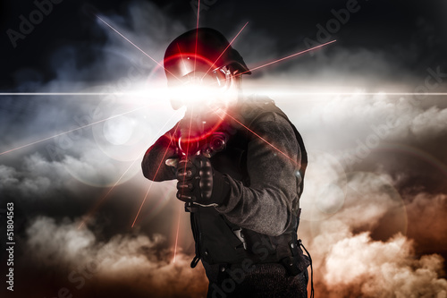 Soldier aiming assault rifle laser sight photo