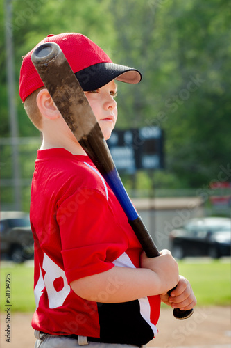 Portrait of child preparing to bat during baseball game