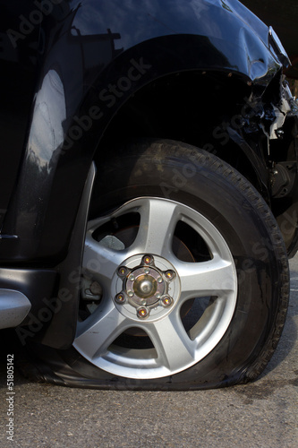 Side of the wheel, flat tire deflated because of an accident
