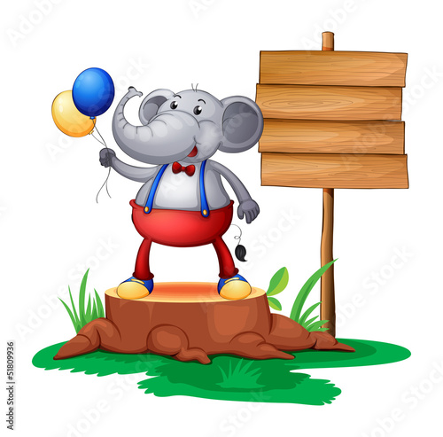 A trunk with an elephant near the wooden signboard