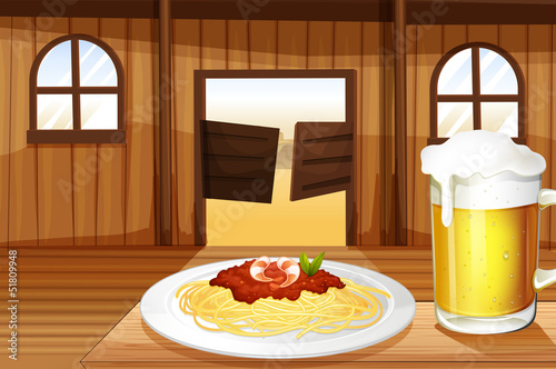 A spaghetti and a glass of beer inside the saloon bar