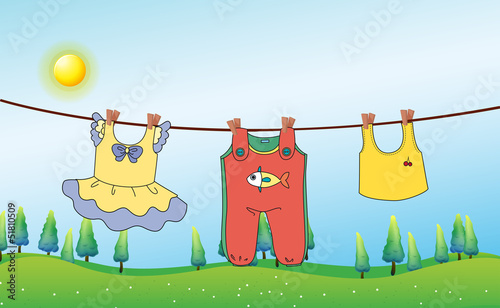 Kids clothes hanging under the sun