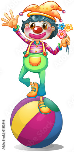 A clown balancing above a ball